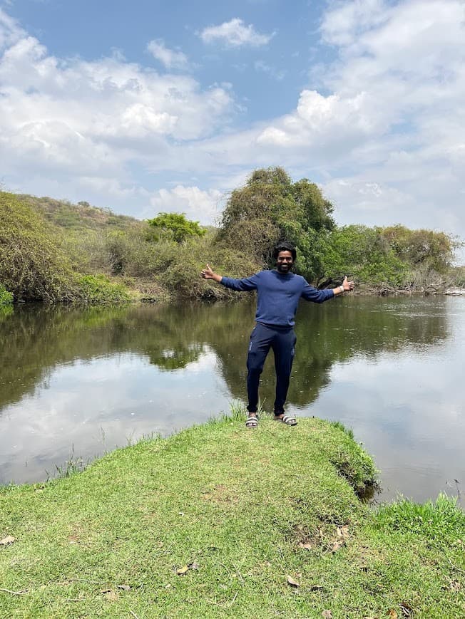 By the water, thumbs up.