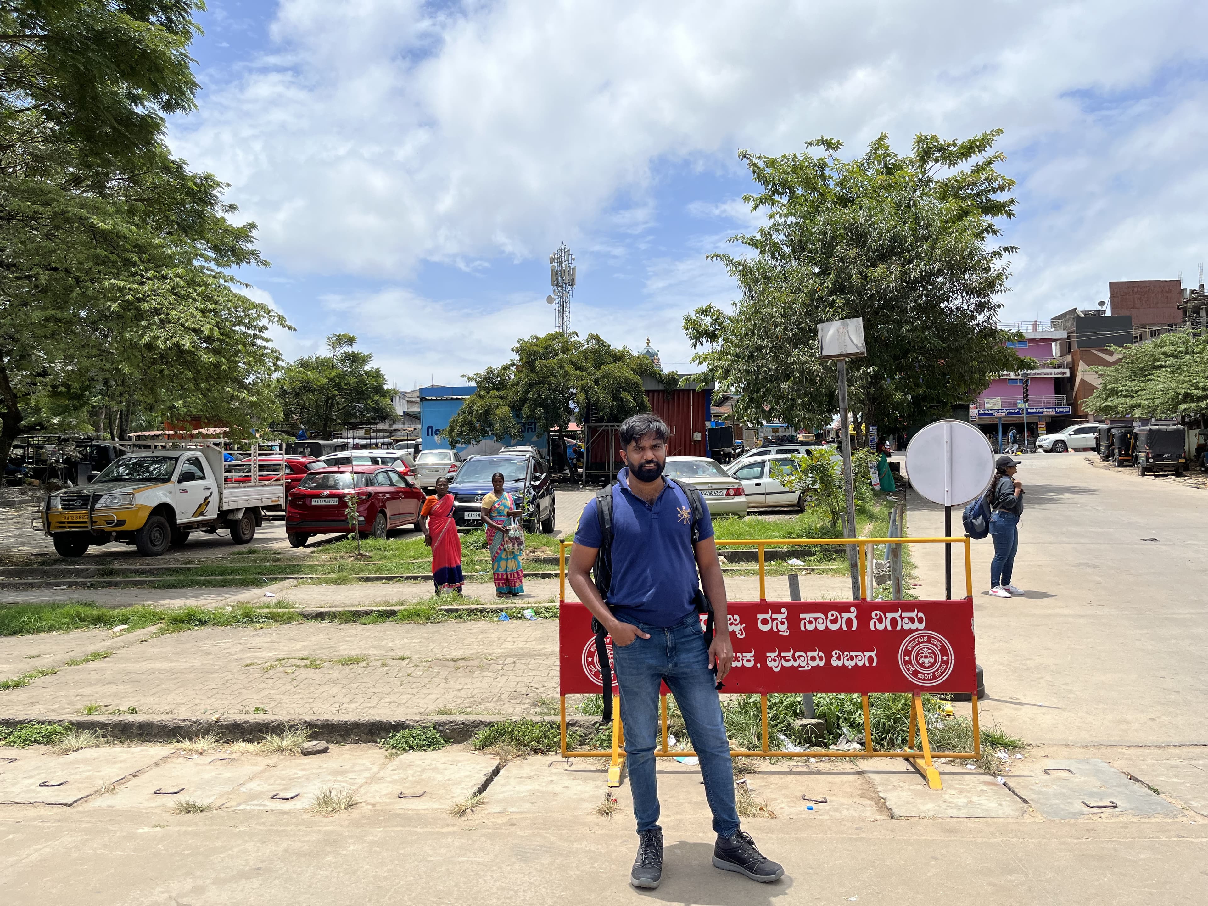 Anand standing at a bus station in Karnataka.