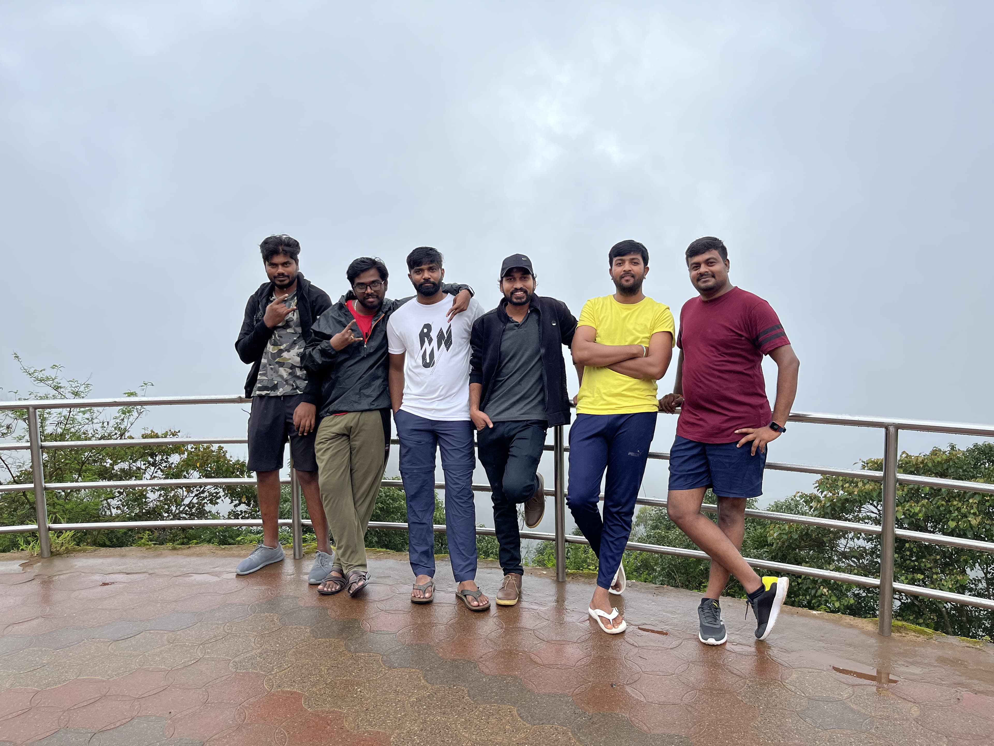 Six of us at a misty railing in Coorg.